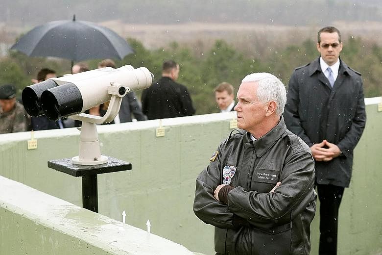 US Vice- President Mike Pence looking towards the north from an observation post in the demilitarised zone separating the two Koreas yesterday. His trip to South Korea follows that of the US Secretary of State and Defence Secretary, with the visits a