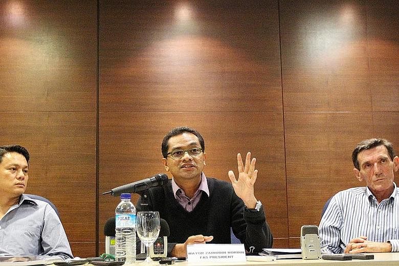 FAS general secretary Winston Lee looking on as then president Zainudin Nordin spoke at a media conference back in January 2011. Game Changers have listed eight questions for Lee to answer.