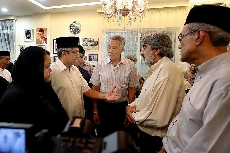 Above: Mr Othman Wok, who was 92, died yesterday at the Singapore General Hospital. Right: (From left) Mr Othman's daughter Diana, Dr Yaacob Ibrahim, Mr Othman's son-in-law Mohd Nazree Basir, PM Lee, and Mr Othman's son-in-law Munir Shah at the late 