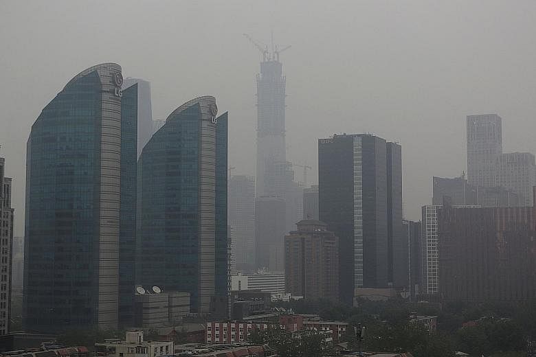 Thick haze blanketing Beijing on Sunday. It is caused by a combination of existing smog in the city and sand blown in from the Gobi Desert in Inner Mongolia.