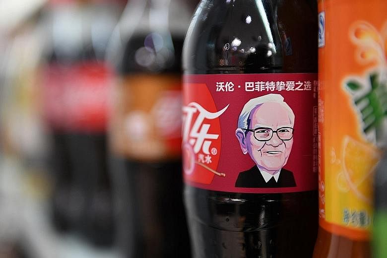 A Cherry Coke bottle featuring an image of US billionaire investor Warren Buffet, who consumes the drink often, seen on a shelf at a convenience store in Beijing.