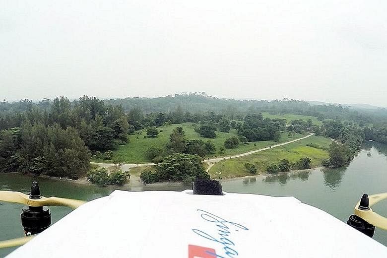 A SingPost drone during a successful delivery trial in September 2015, when it delivered a letter and T-shirt from Lorong Halus to Pulau Ubin. In the planned live test at NUS early next year, autonomous drones will fly on pre-defined routes to drop o