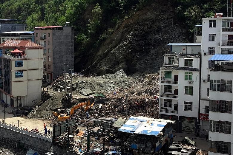 An avalanche of soil and debris swept down a hill in north-western China's Shaanxi province on Monday, flattening a seven-storey apartment building and killing three people. The landslide, triggered by heavy rains over the last weekend, forced the ev