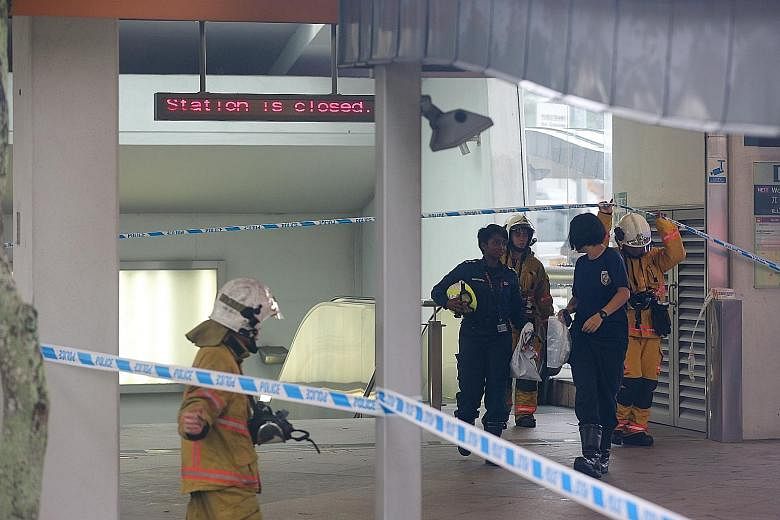 Singapore Civil Defence Force officers at Woodleigh MRT station yesterday, where the substance that later turned out to be flour was found at several spots.