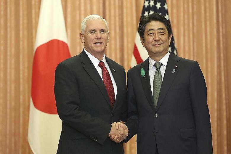 US Vice-President Mike Pence with Japan's Prime Minister Shinzo Abe in Tokyo yesterday. Mr Pence reiterated Washington's commitment to Japan's security in the face of the nuclear threat from North Korea.