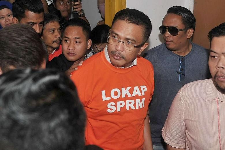 Abdul Latif Bandi arriving in court yesterday. His case involves alleged kickbacks to convert housing lots that can be bought only by bumiputeras into non-bumiputera lots, which fetch higher prices, say local media. 