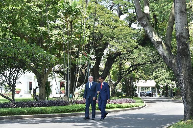 Mr Mike Pence and Mr Joko Widodo at the Merdeka Palace yesterday. Mr Pence also visited a mosque in Jakarta.