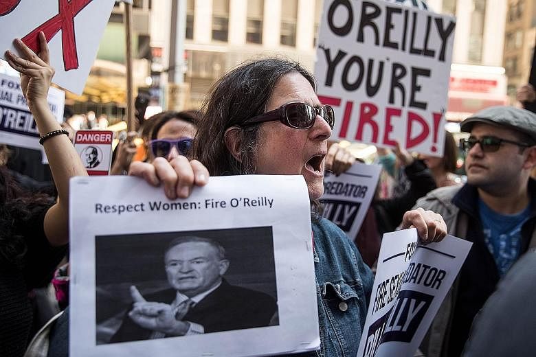 Protesters at a rally against top cable news anchor Bill O'Reilly outside Fox News' headquarters in Midtown Manhattan, New York City, on Tuesday.