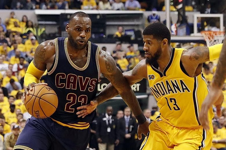 LeBron James (left) goes up against Indiana Pacers forward Paul George.