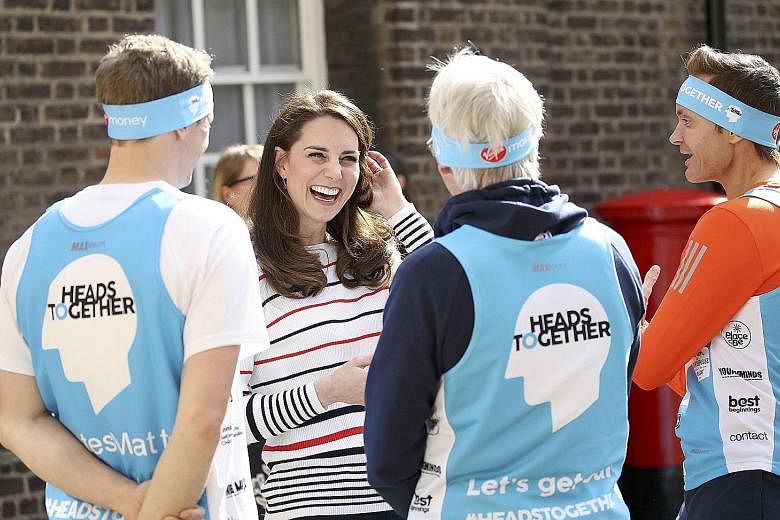 The Duchess of Cambridge speaking with runners at Kensington Palace before the Virgin Money London Marathon. Catherine, who has a chirpy public image, admitted on Thursday that motherhood can be isolating at times.