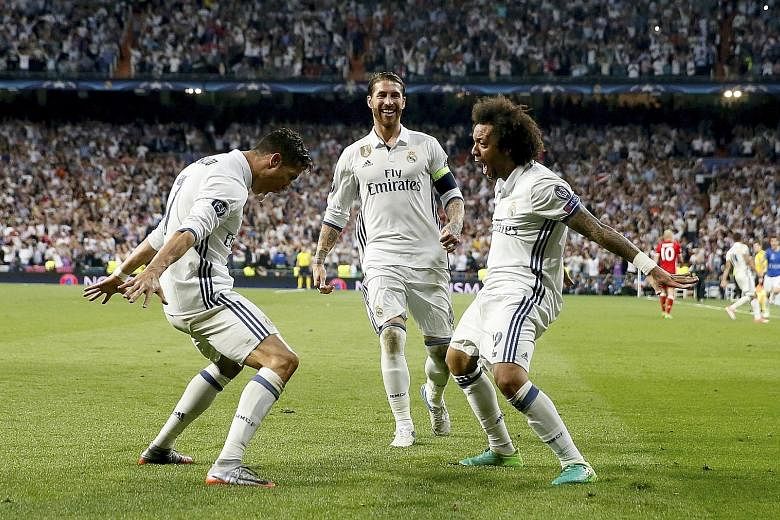 Real Madrid forward Cristiano Ronaldo (left), captain Sergio Ramos (centre) and defender Marcelo celebrate Ronaldo's third goal against Bayern Munich during their Champions League quarter-final second-leg match at the Bernabeu. The Portuguese made it