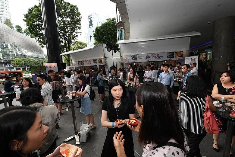 At the Local Gourmet Fiesta outside Shaw House, visitors can tuck into salted egg chicken burger, tempura kimchi popiah and other delicious food.