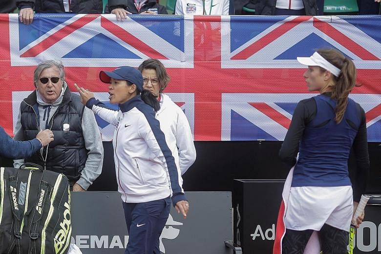 Britain's head coach Anne Keothavong gestures towards Romania's head coach Ilie Nastase during the Fed Cup Group II play-off yesterday. The veteran, who won the 1972 US Open and 1973 French Open, was removed from his duties after profanities against 