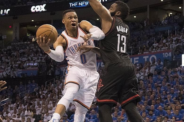 Russell Westbrook of the Oklahoma City Thunder drives around James Harden of the Houston Rockets while shepherding his team to a 115-113 win in Game Three of the Western Conference play-offs. His on-court decision making was crucial in the win.