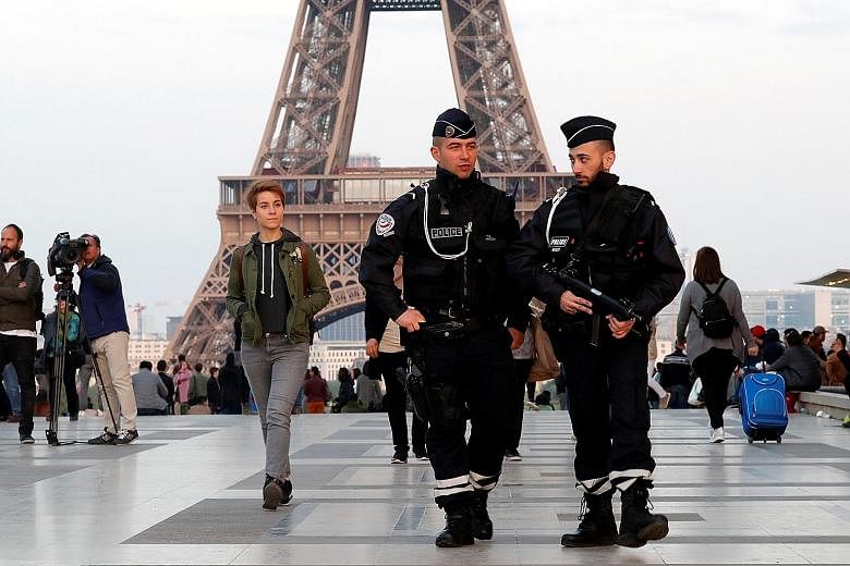 Police patrolling an area near the Eiffel Tower last Friday, the day after a policeman was killed and two others were wounded in a shooting incident on Paris' Champs Elysees.