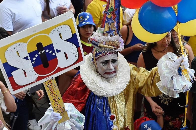Protesters in the US state of Florida at a rally against the Venezuelan government last week. Venezuela is in the grip of escalating violence as President Nicolas Maduro faces calls for his ouster from the opposition. He says the protests against him