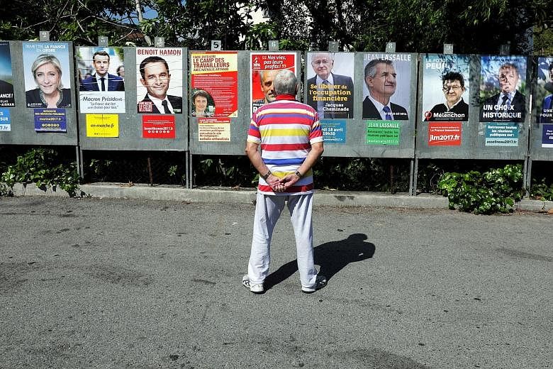 Sizing up the candidates running in the French presidential election, in Saint Andre de La Roche, near Nice.