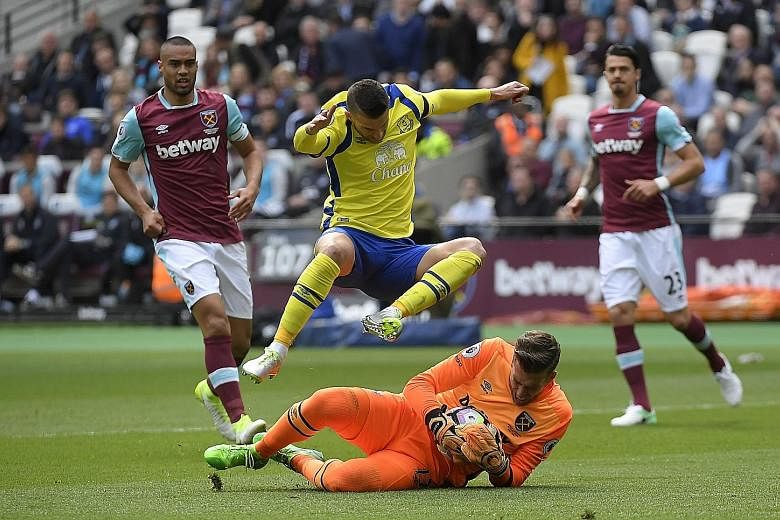 Everton's Kevin Mirallas leaps over West Ham goalkeeper Adrian as the latter makes a save. The Premier League match ended goalless, and puts a dampener on Everton's charge for a European spot.