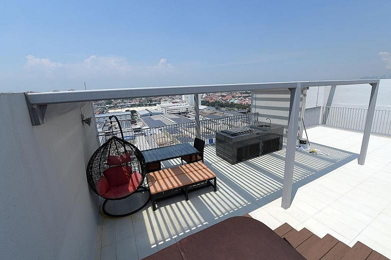 Some owners of penthouse units at condominium Bedok Residences have avoided using the barbecue pits and jacuzzis on their private roof terraces when they saw that the lightning rods connect to the metal rails and facades of the units (above right). H