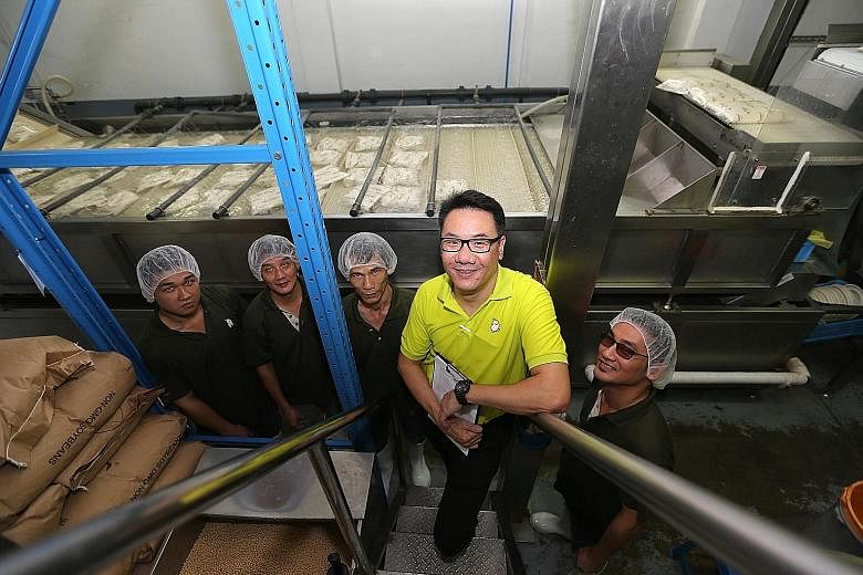 Mr Bean's central kitchen manager, Mr Jerome Ang (in yellow), with (from left) production crew member Chua Zheng Beng, assistant central kitchen manager Tan Hock Ting, line leader Heong Chen Kheong and line supervisor Lam Wing Phong. Automation has e