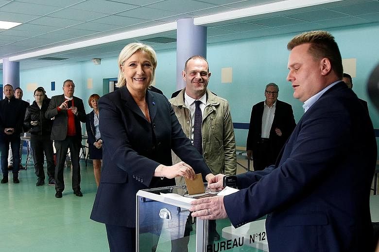 Far-right leader Marine Le Pen, who cast her ballot in Henin-Beaumont, northern France, proposes a more disruptive programme of higher social spending than Mr Macron, who favours gradual economic deregulation. Mr Emmanuel Macron at a polling station 