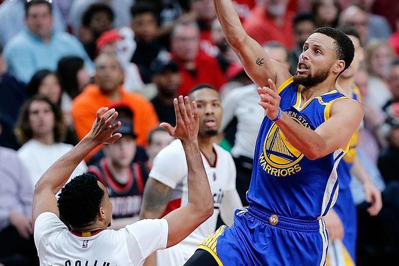 Golden State Warriors point guard Stephen Curry scoring on a lay-up over Portland's C.J. McCollum. Curry poured in 34 points, with 14 coming in the fourth quarter as the Warriors beat the Trail Blazers 119-113 to take a commanding 3-0 lead in their f