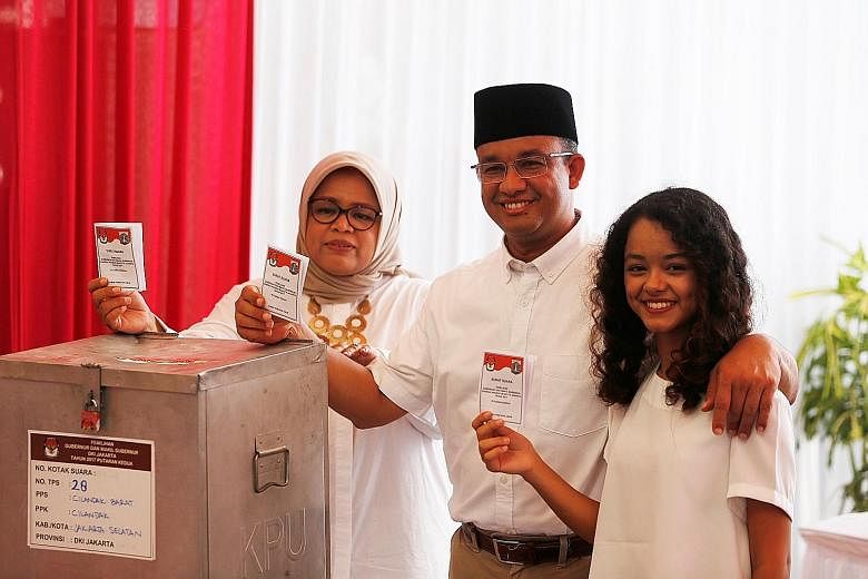 Jakarta gubernatorial candidate Anies Baswedan casting his vote with wife Fery Farhati Ganis and daughter Mutiara Annisa in the election in South Jakarta, Indonesia, last Wednesday.