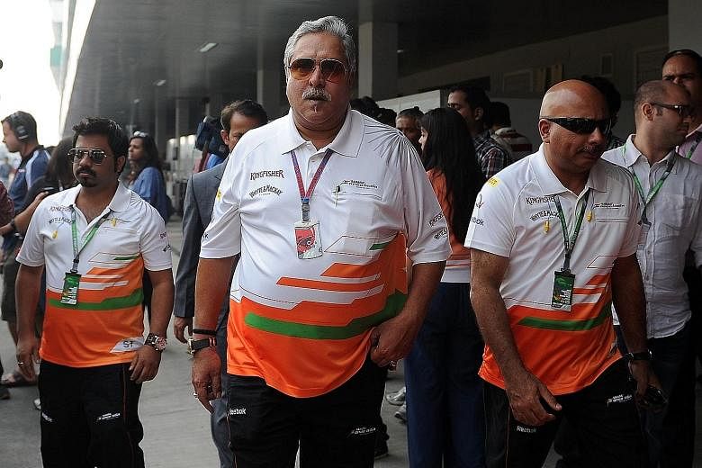 Kingfisher Airlines founder Vijay Mallya (centre) at a 2012 Formula One event. Last week, he was arrested by Scotland Yard and then released on bail in what the Indian authorities said was the beginning of extradition proceedings.