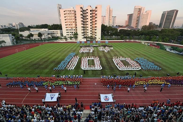 Left: A reunion for Nan Hua Primary School and Nan Hua High School was held last Friday at the NUS High School of Mathematics and Science, the schools' first site in Clementi. Above: More than 1,400 students from both schools put on performances to m