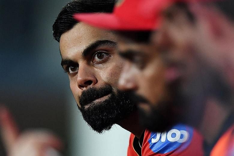 Royal Challengers Bangalore captain Virat Kohli watching his team slump to an IPL-record total of just 49. The powerful batting line-up lasted just 58 deliveries.