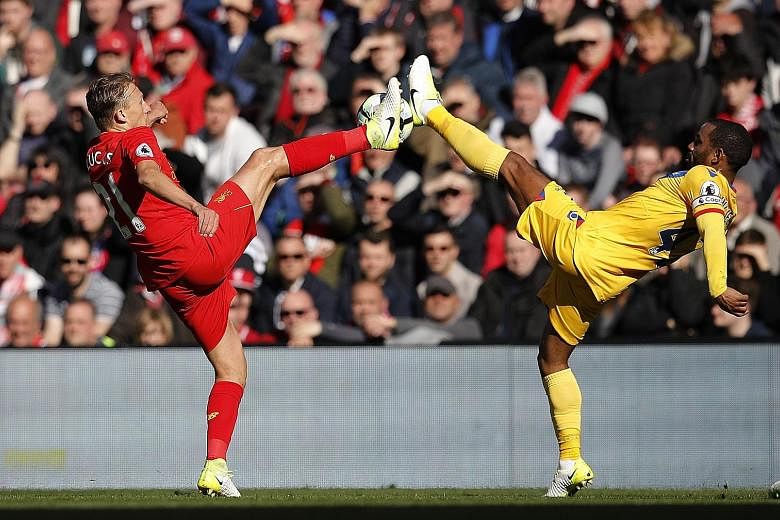 Crystal Palace's Jason Puncheon (No. 42) battling for the ball with Lucas Leiva of Liverpool. The Reds slumped to a 1-2 loss at home to Palace, which damaged their hopes of Champions League football next season.