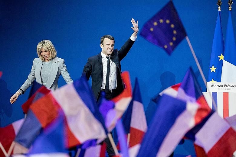 Presidential candidate Emmanuel Macron and his wife Brigitte Trogneux arriving at Parc des Expositions in Paris, France, on Sunday to deliver a speech after the first round of voting in the election.