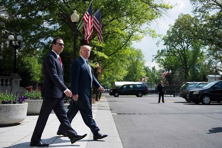 US President Donald Trump with Treasury Secretary Steven Mnuchin outside the White House last Friday. Mr Trump is scrambling to show progress on two leading priorities - healthcare reform and tax cuts.