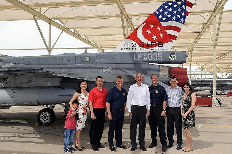 DPM Teo Chee Hean with Lt-Col Kenneth Lim (in red shirt) and his family, and (from left) Brig-Gen Brook Leonard, 56th Fighter Wing Command Chief Master Sergeant Randy Kwiatkowski, and Peace Carvin II US Air Force detachment commander Lt-Col Jason Coo
