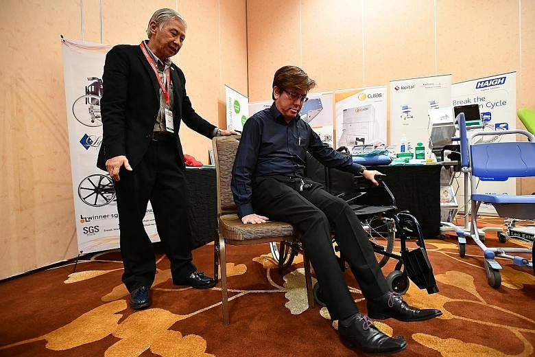 Education manager Donavan Tan, 37, demonstrating how to use Sci-Fit's lateral exercise machine, which targets muscles in the upper leg and helps to improve lateral stability, hence preventing falls among the elderly. It can also be used for rehabilit