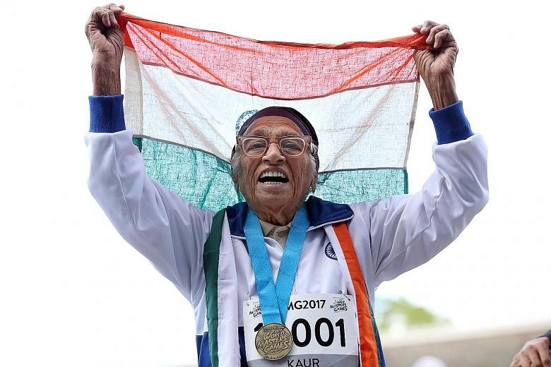 101-year-old Man Kaur celebrating winning the 100m sprint at the World Masters Games. She was the sole competitor in the 100-and-over race.