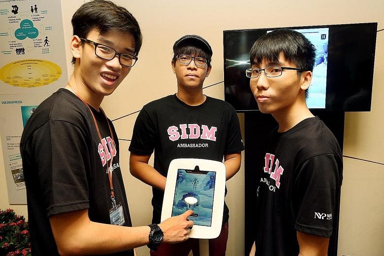 (From far left) Nanyang Poly students Tan Kin Lek, Ivan Leong and John Leong are among the developers of an anti-drug game called Narcaution.