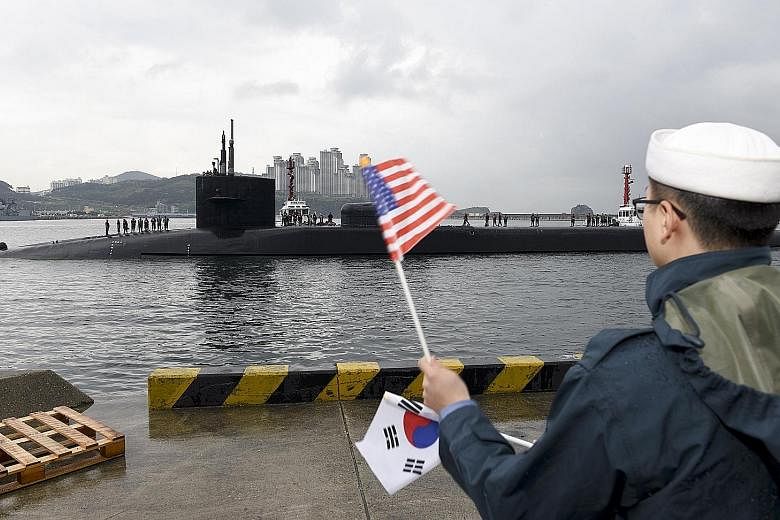 A US Defence Department handout photo showing the USS Michigan submarine arriving in Busan, South Korea, yesterday. It is set to join the USS Carl Vinson aircraft carrier in drills near the Korean peninsula.