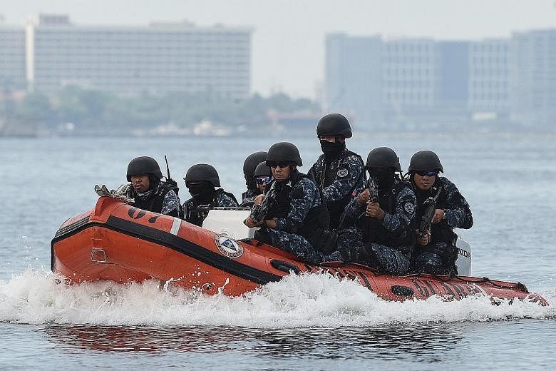 A Philippine Coast Guard unit in a security drill off Manila Bay near the Asean Summit venue yesterday.