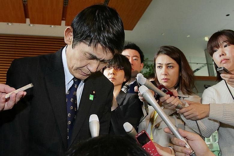 Japan's minister in charge of reconstruction of disaster-hit Tohoku region, Mr Masahiro Imamura, expressing regret yesterday for his remarks about the 2011 quake, which sparked outrage.