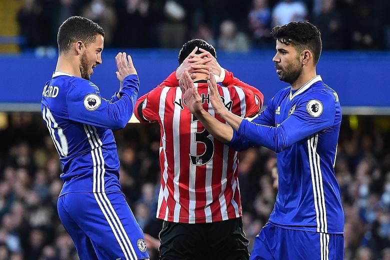 Chelsea midfielder Eden Hazard (left) celebrates his fifth-minute opener against Southampton with Diego Costa. The Spain striker provided the assist before scoring two goals of his own at Stamford Bridge.