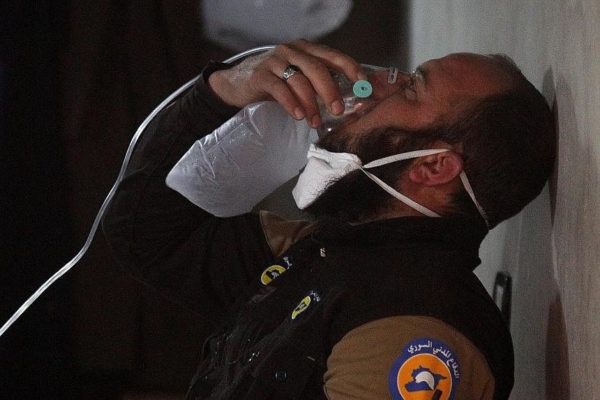 A Syrian civil defence member getting some oxygen after a suspected chemical weapons attack on Khan Sheikhoun on April 4. A French report says President Bashar al-Assad or members of his inner circle ordered it.