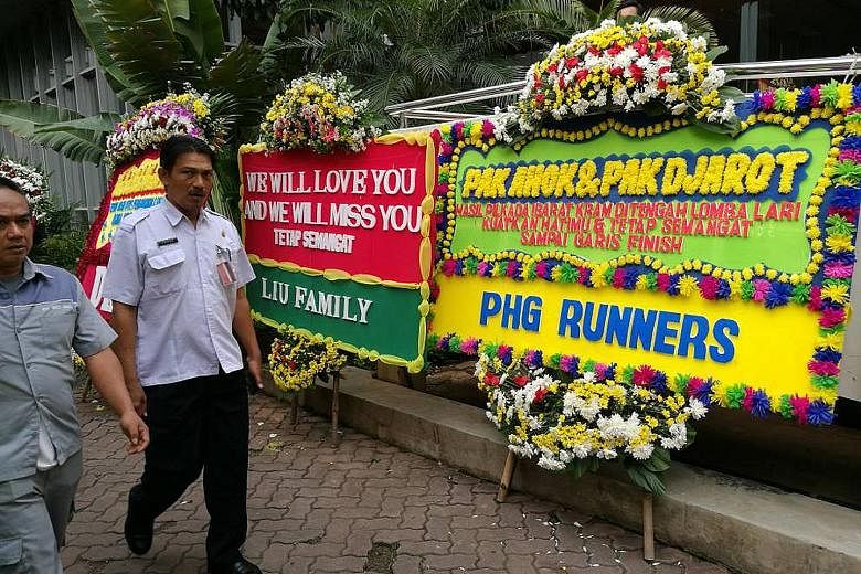 Flower stands with messages of gratitude for Basuki and his running mate Djarot Saiful Hidayat at City Hall yesterday.