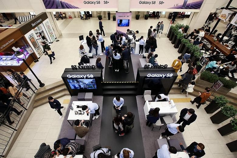 Samsung's premium phone, the Galaxy S8, being promoted at an exhibition booth in Seoul earlier this month. The South Korean conglomerate, which turned in a strong financial performance despite recent challenges, said that it would not pursue a holdin
