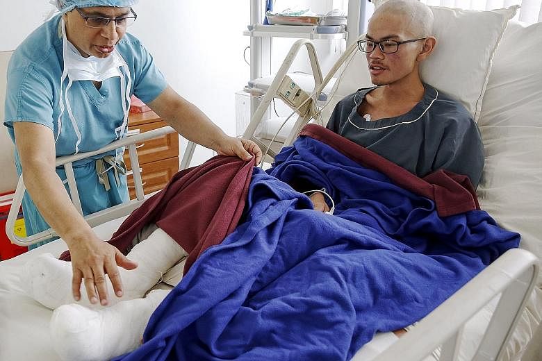 Rescued Taiwanese trekker Liang Sheng-yueh, who lost 30kg after being stranded for 47 days with his girlfriend on a mountainside in north-west Nepal, being checked by Dr Chakra Raj Pandey at Grande International Hospital in Kathmandu.