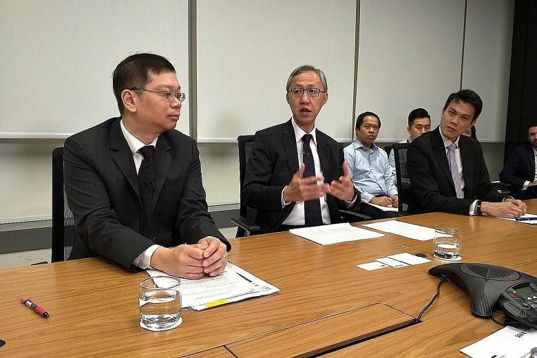 Professor Tan Cheng Han (centre), RegCo chairman, with CEO Tan Boon Gin (left) and regulatory development head Chew Chin Yee at a press briefing yesterday. Prof Tan said he will bring "a pair of fresh eyes" to the review process.