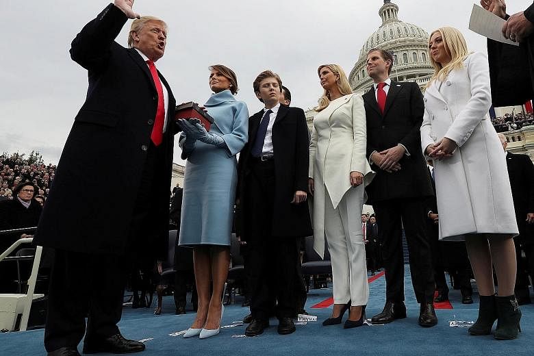 Mr Donald Trump being sworn in as US President in Washington on Jan 20, watched by (from left) his wife Melania and his children Barron, Ivanka, Eric and Tiffany. After 100 days in office, Mr Trump seems to have lost some of his bluster but none of h