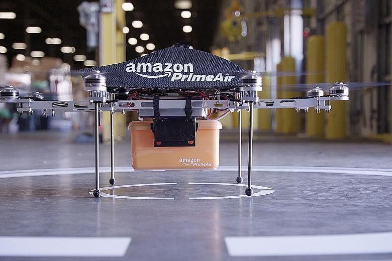 Amazon's Prime Air drone, which can deliver goods. The firm's efforts in drone deliveries have been stymied by outdated rules, says the writer.