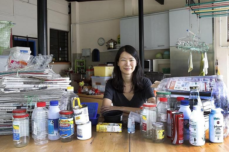 Retiree Peter Lo started a recycling drive in seven zones in his Sembawang neighbourhood that is still ongoing to this day. The items freelance writer Olivia Choong (above) collects in her home for recycling include used newspapers, milk cans and pla