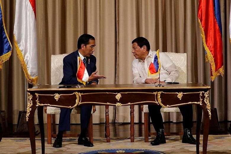 Philippine President Rodrigo Duterte (right) had talks yesterday with visiting Indonesian President Joko Widodo at the presidential palace ahead of the Asean summit in Manila. The two countries agreed to step up efforts to combat terrorism, piracy an